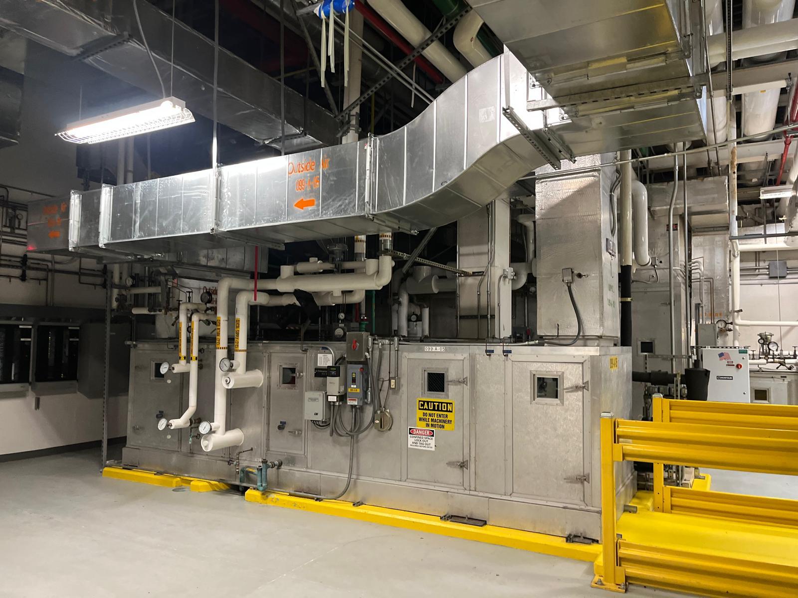 Insulated pipe and ductwork running through a plant corridor