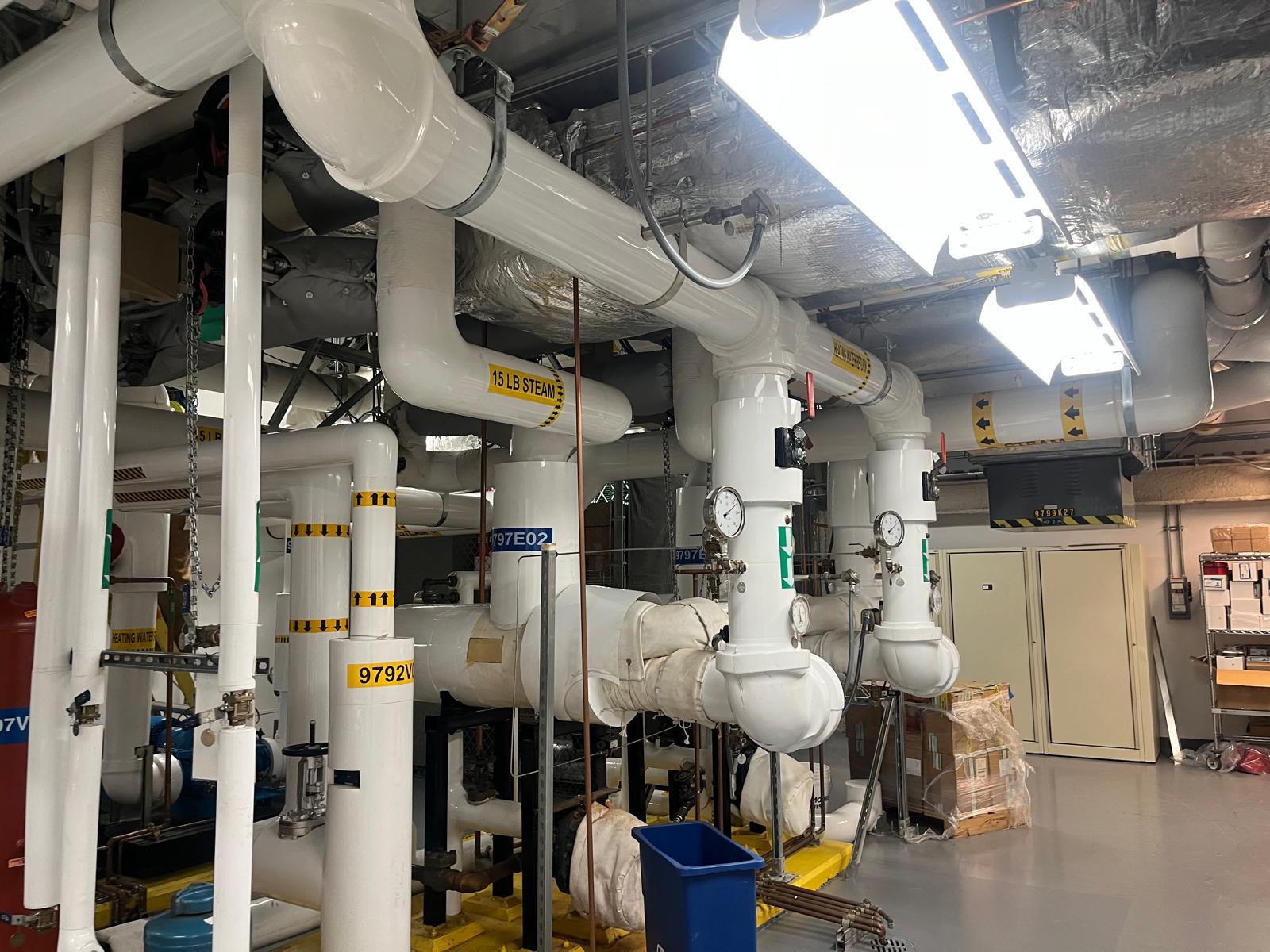 Insulated pipe runs in an operating mechanical room